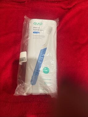 New with seal in tack- quip Electric Toothbrush in White with Blue Accent